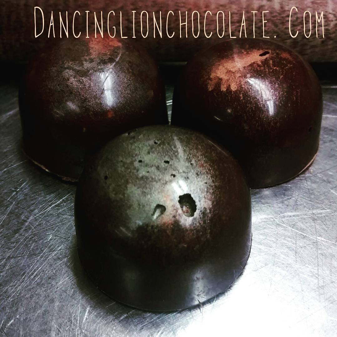 Capped - candied cacao nibs, toasted pistachios, Mexican vanilla, & currants in a crunchy 3-chocolate cap