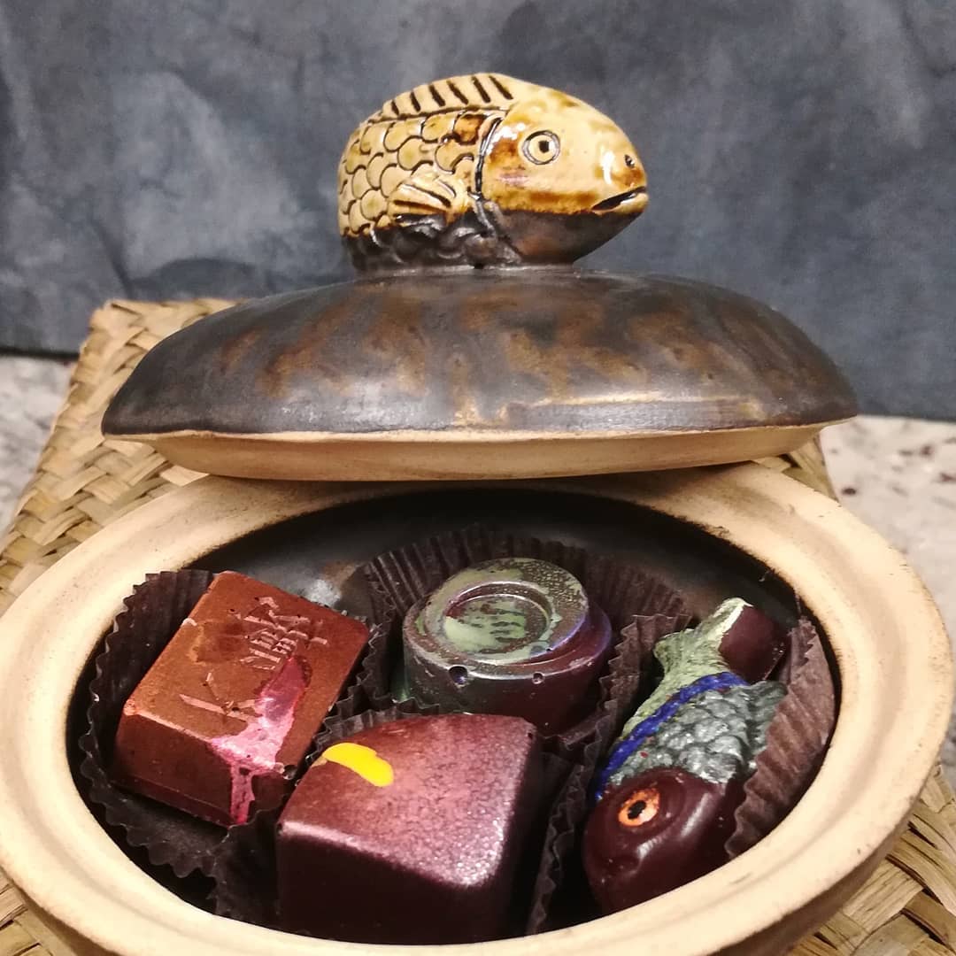 Thai Animal Dish with Four Bonbons.I found two of these elegant ceramic dishes--one  with a fish lid and one with a turtle. We filled each with an assortment of our latest bonbons.#chocolatier #boxofchocolates #gift.